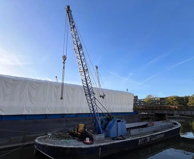 Crane barge on the river, rigged and ready to lift